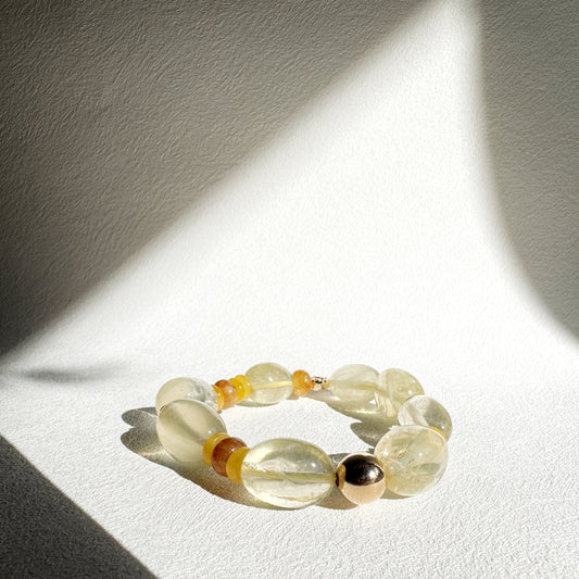 Beaded bracelet with yellow and black beads on a white surface