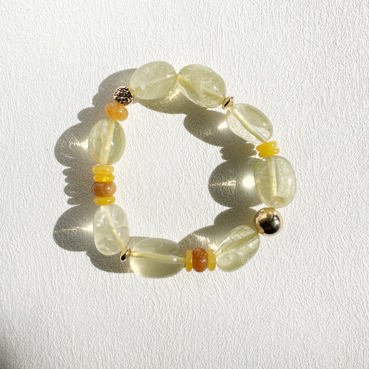 Beaded bracelet with yellow and orange accents on a white background