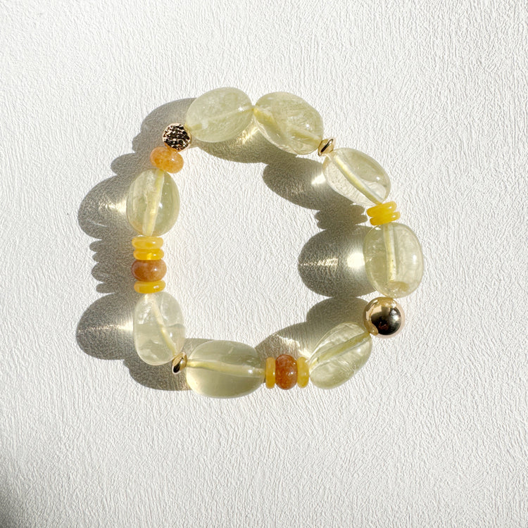Beaded bracelet with yellow and orange accents on a white background