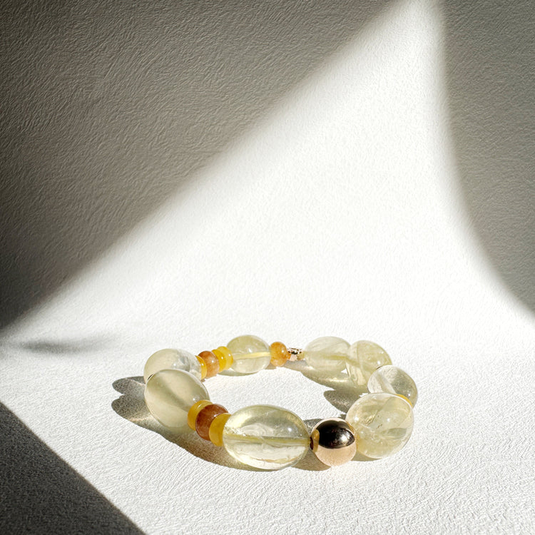 Beaded bracelet with yellow and black beads on a white surface