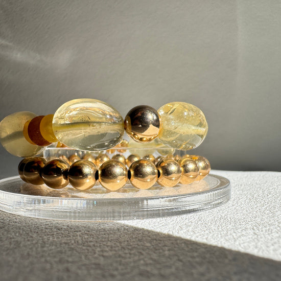 Decorative wall light fixture with glass beads on a neutral background