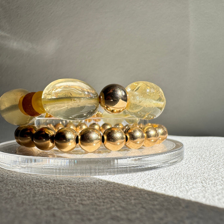 Decorative wall light fixture with glass beads on a neutral background