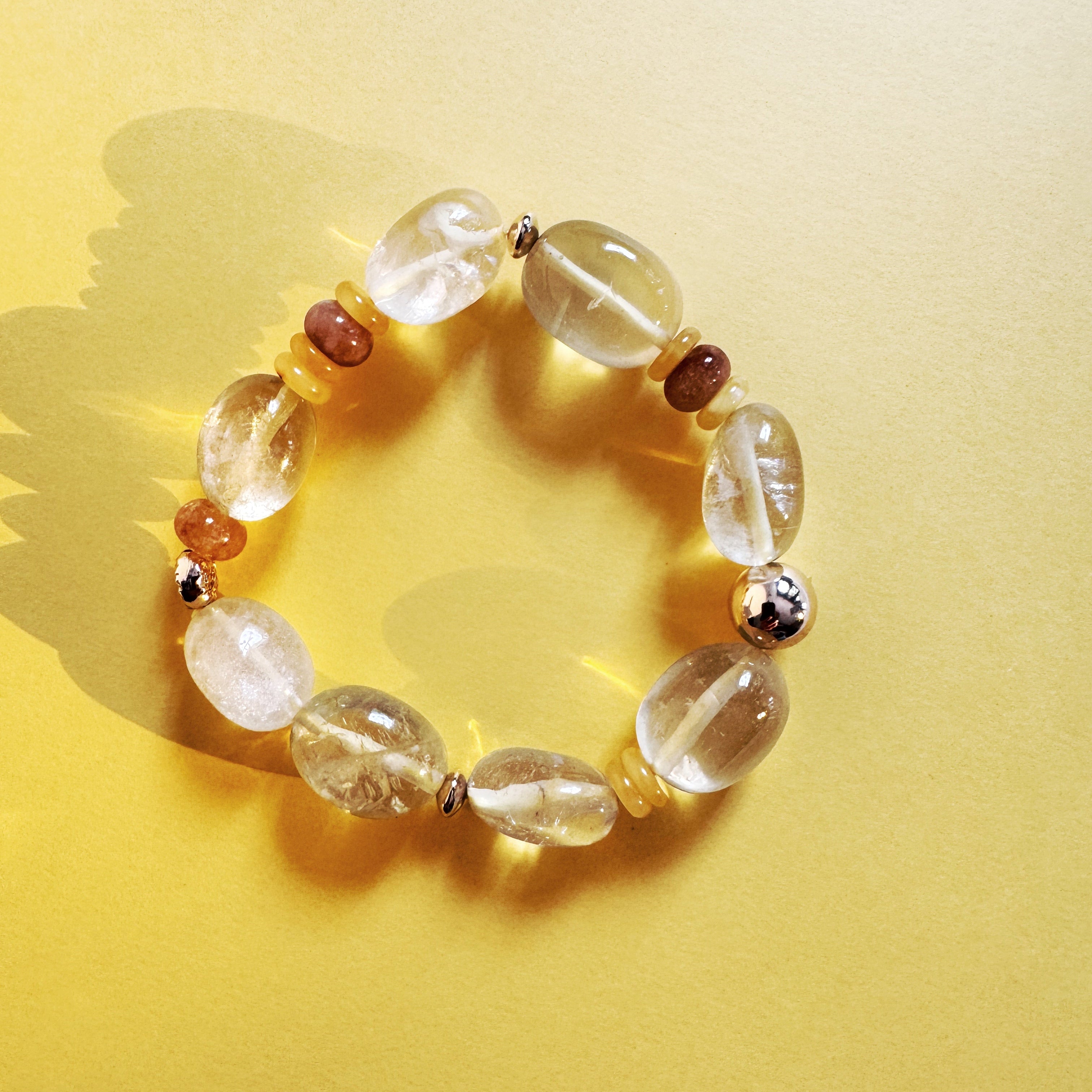 Bracelet with clear and brown beads on a yellow background